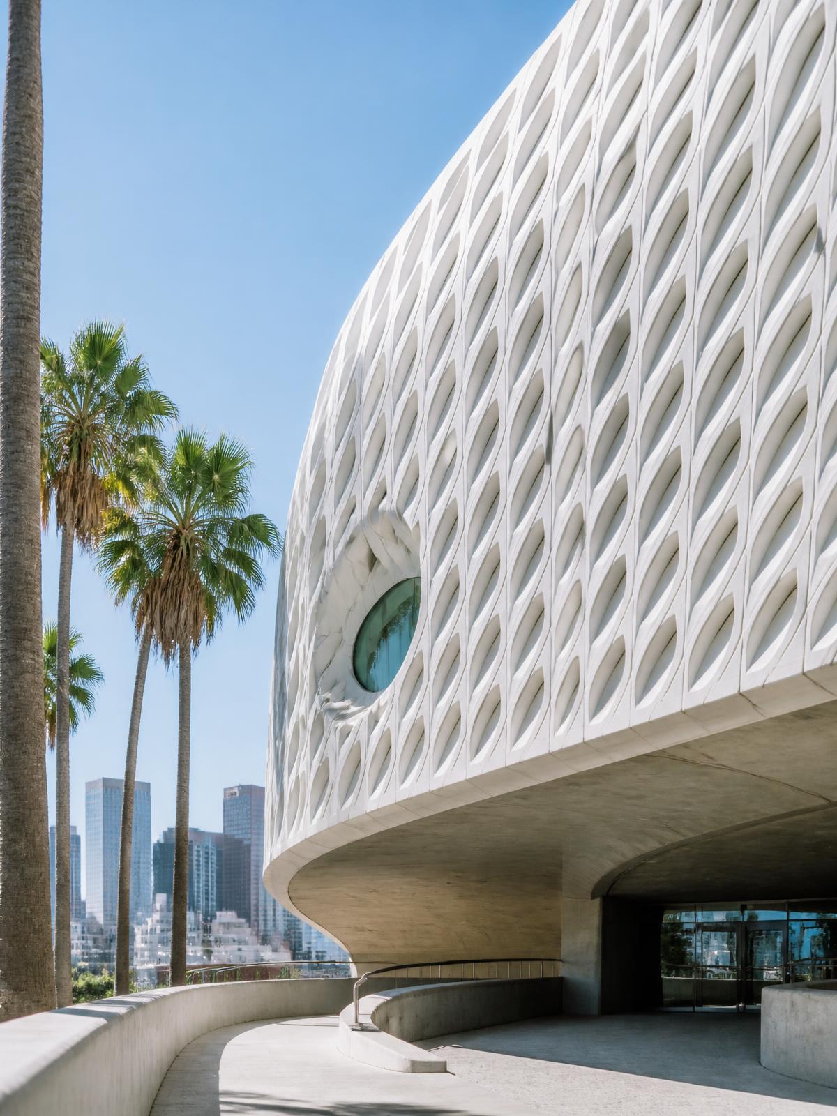 Contemporary Los Angeles architecture framed by palm trees and clear blue sky